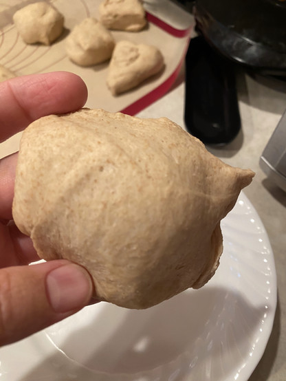 the smoothest side of one particular lump of dough. It's not amazingly smooth but it's the least unsmooth. You can see very irregular dough lumps in the background; they'll all be fine in the end. the smoothest side of one particular lump of dough. It's not amazingly smooth but it's the least unsmooth. You can see very irregular dough lumps in the background; they'll all be fine in the end.