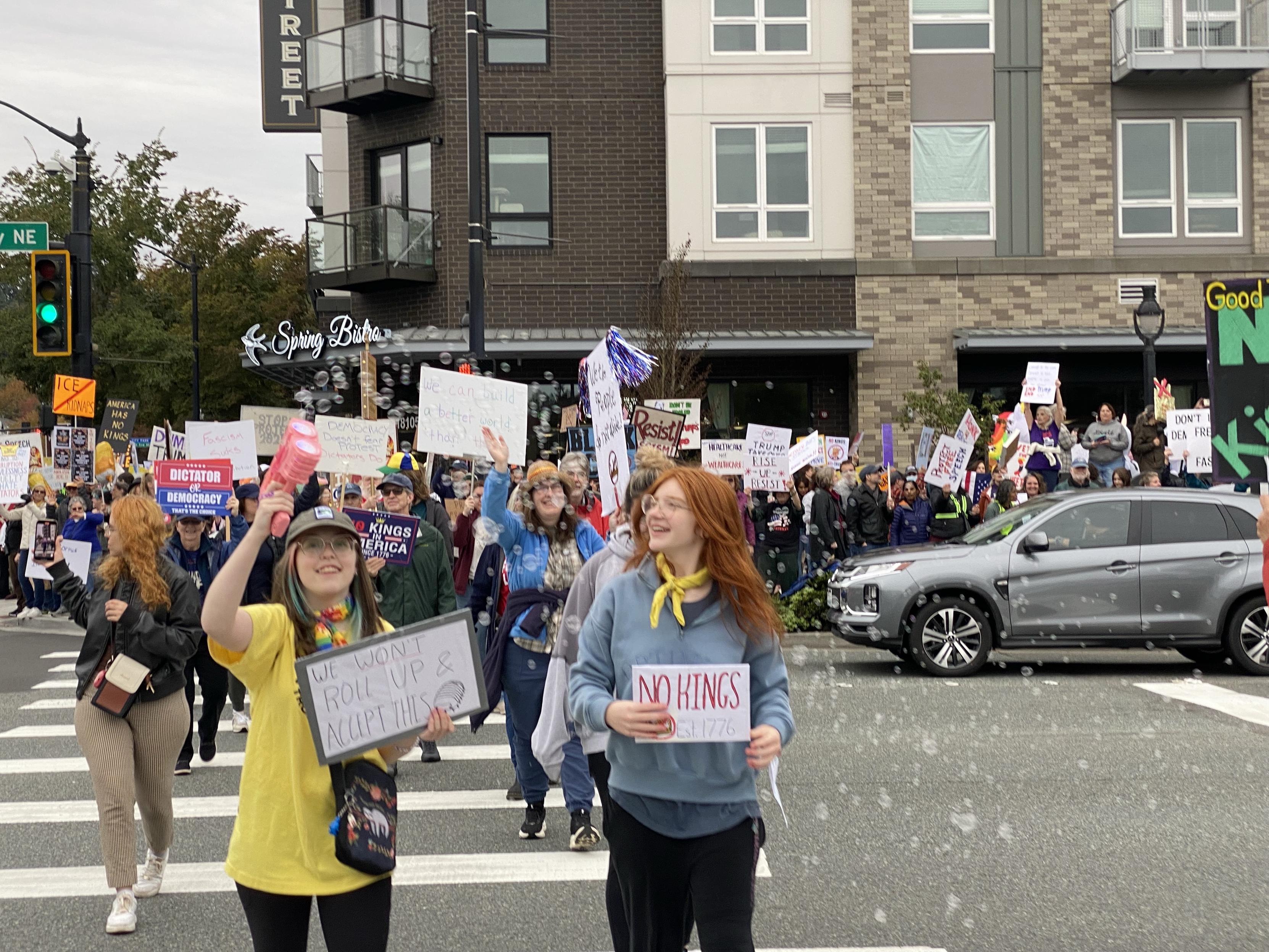 crossing bothell way with a big oncoming crowd of protesters