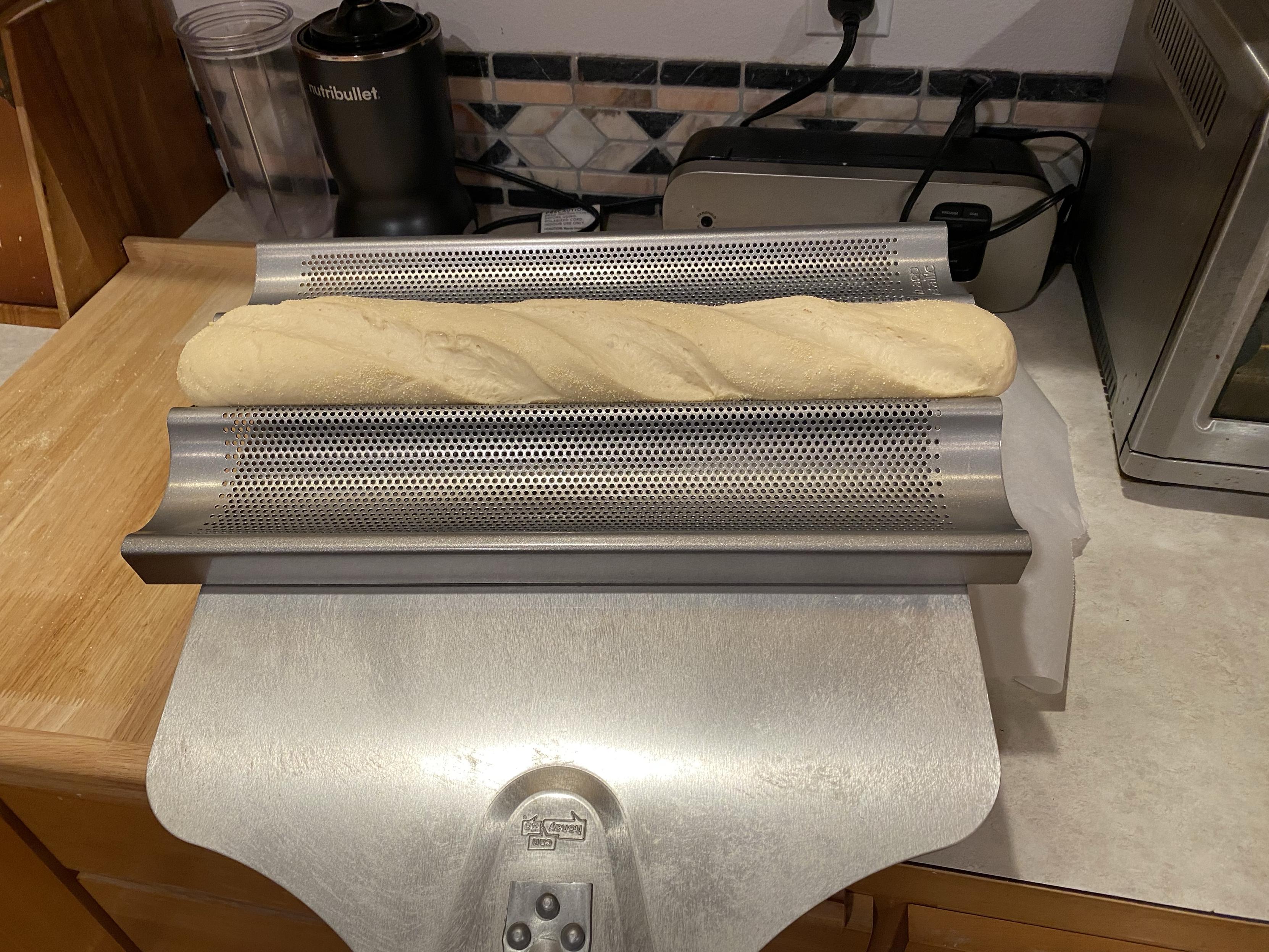 oven spatula, special tray, risen baguette ready for the oven