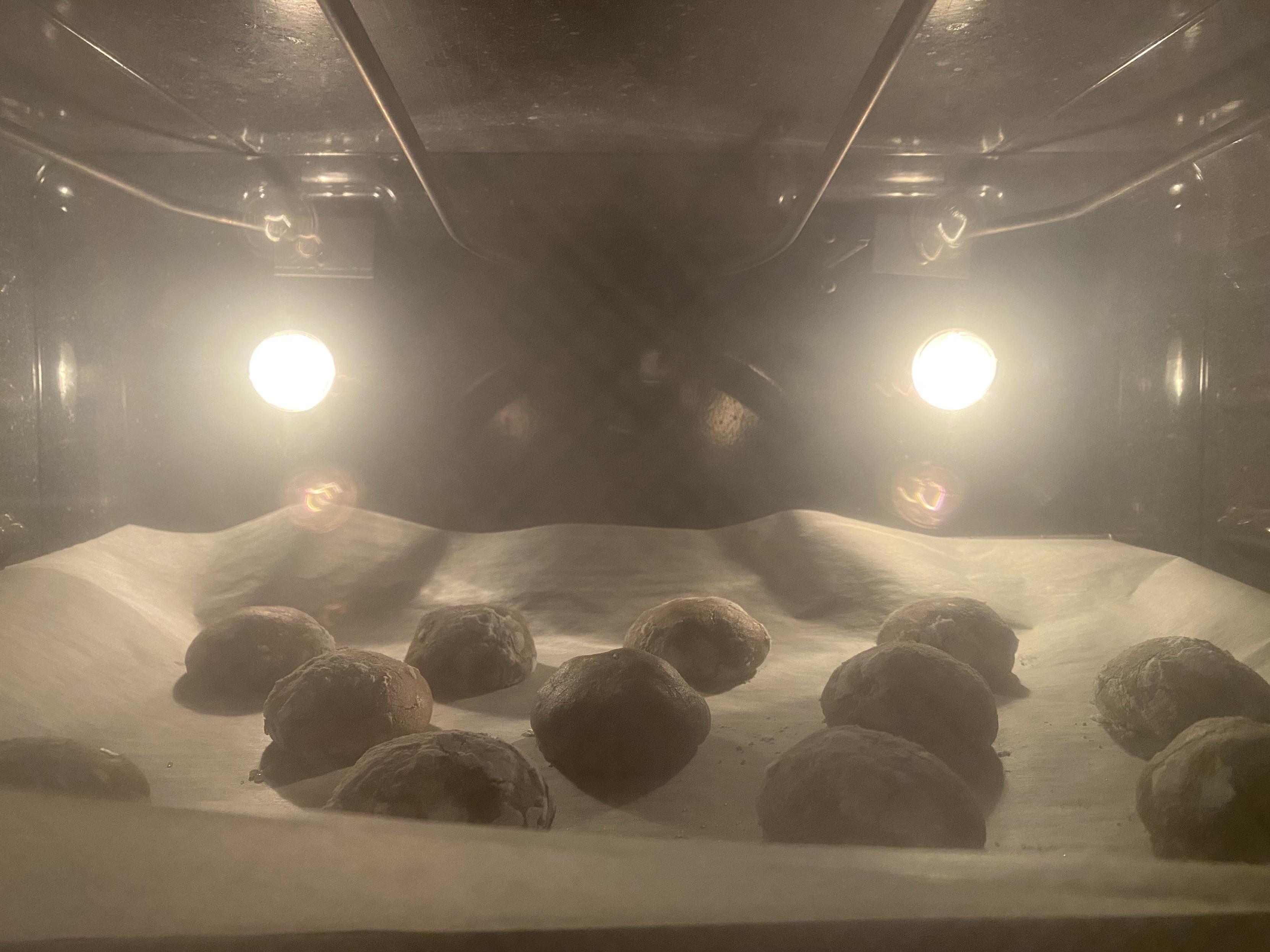 dough balls starting to settle in the oven and just start to crack