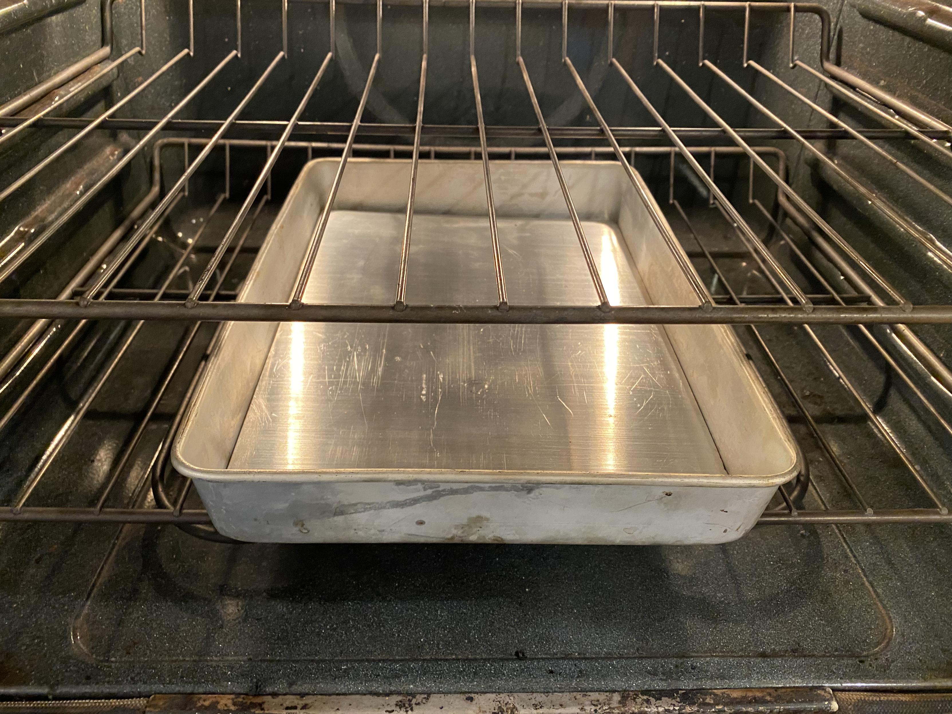 a large aluminium baking pan with the bottom lined with an additional 1/4" aluminium slab covering the entire area of the bottom for thermal mass, sitting on a rack in bottom position below the baguette rack in middle position. throw water onto this after putting in the loaves to cook and it's steam pretty much instantly.