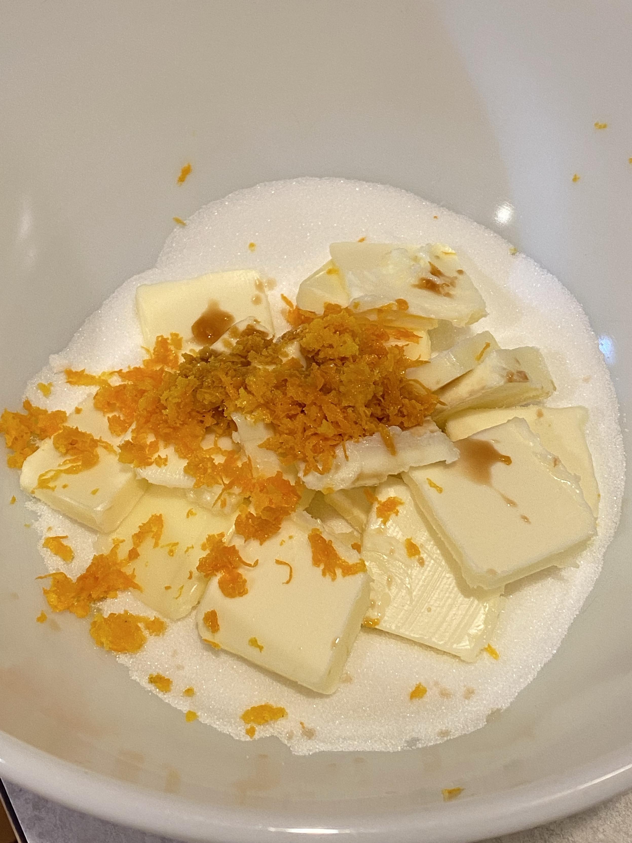 butter vanilla sugar orange zest in a bowl about to be beaten together