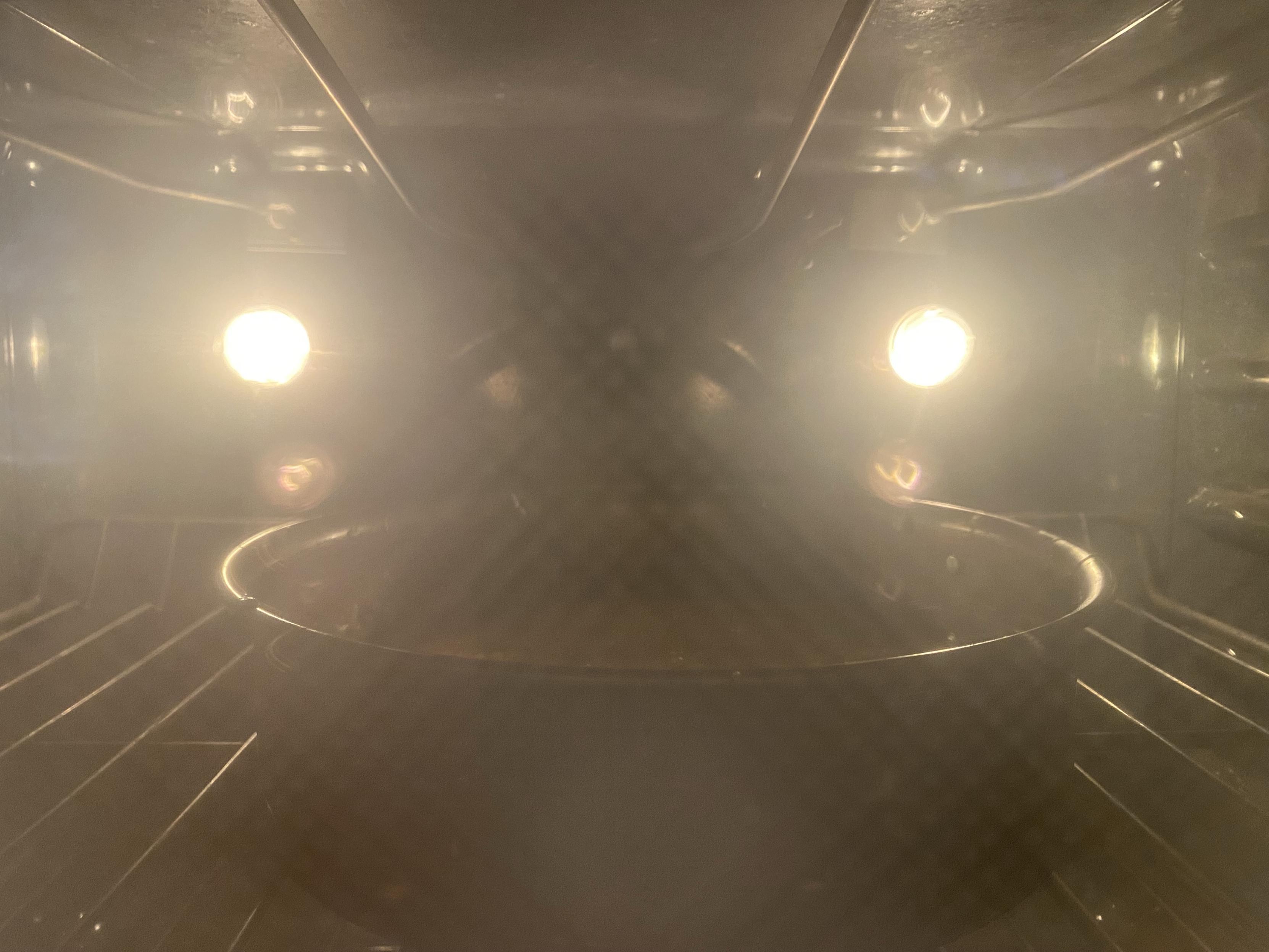 the same cake pan now seen in a oven through a glass oven door that’s kinda fuzzy