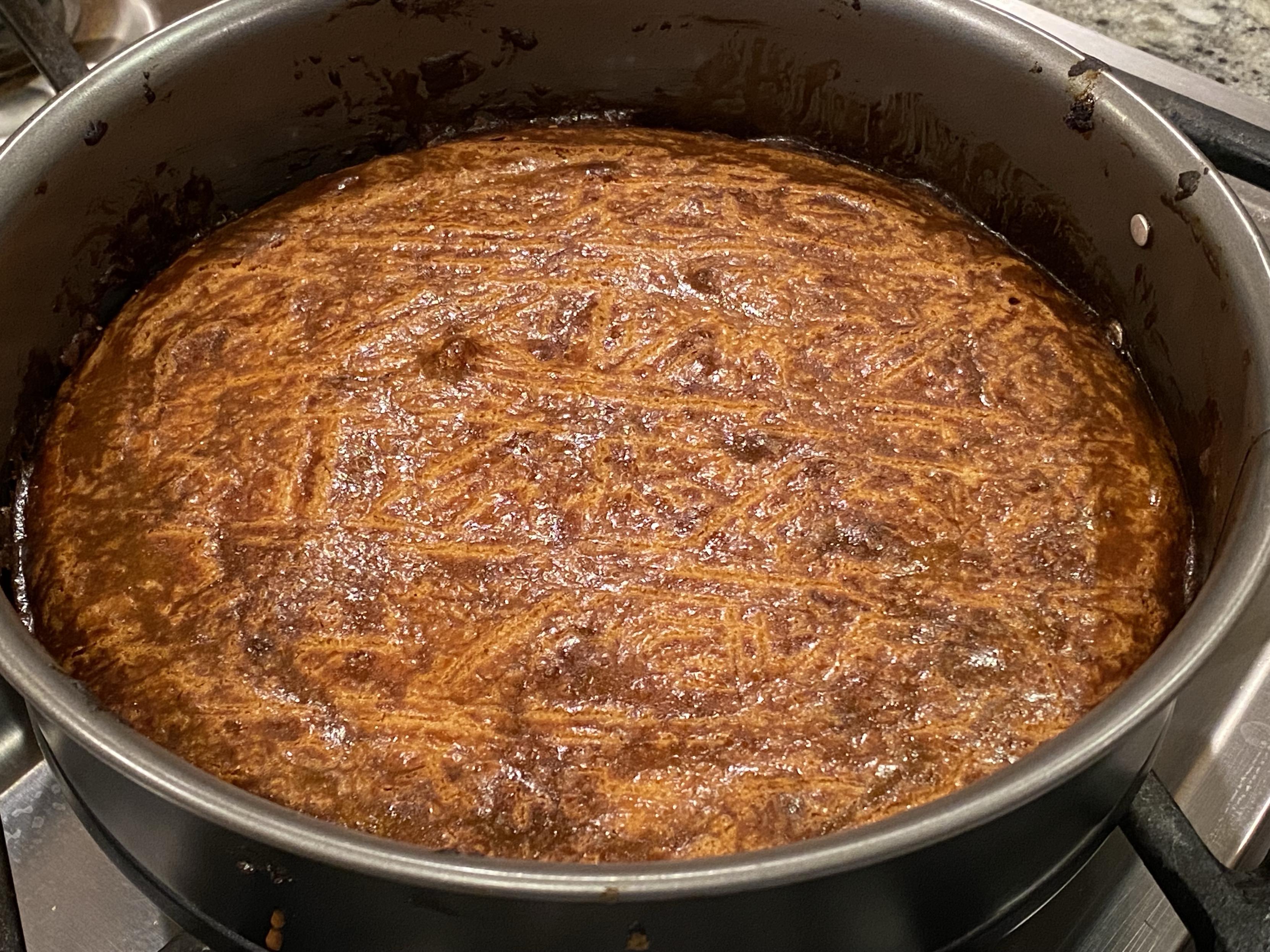 Probably a bit overdone breton butter cake, out of the oven, cooling in its pan atop the stove grate as a rack