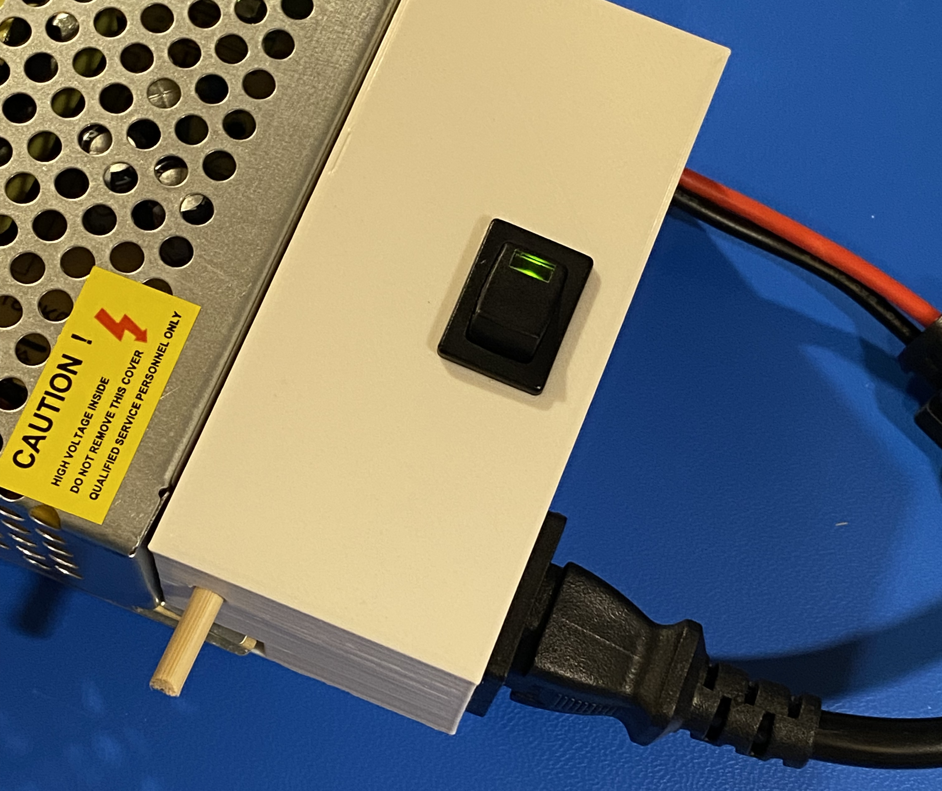 The box extension previously shown here in a complete print form, with the power sockets and switch installed. The switch is in the "on" position and a little green light built into the switch shows DC power out is working.