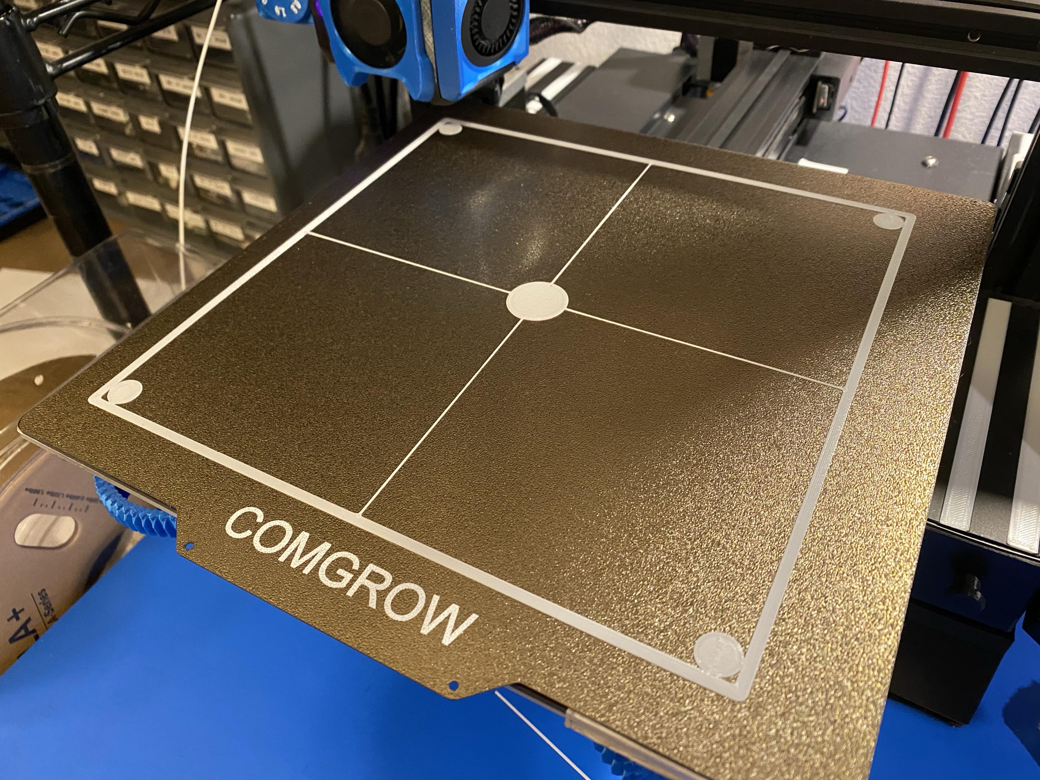 a properly printed full-dimension first layer test print in the cheapest PLA I own, it’s a big square divided into four smaller squares and at every line intersection there is also a filled-in circle