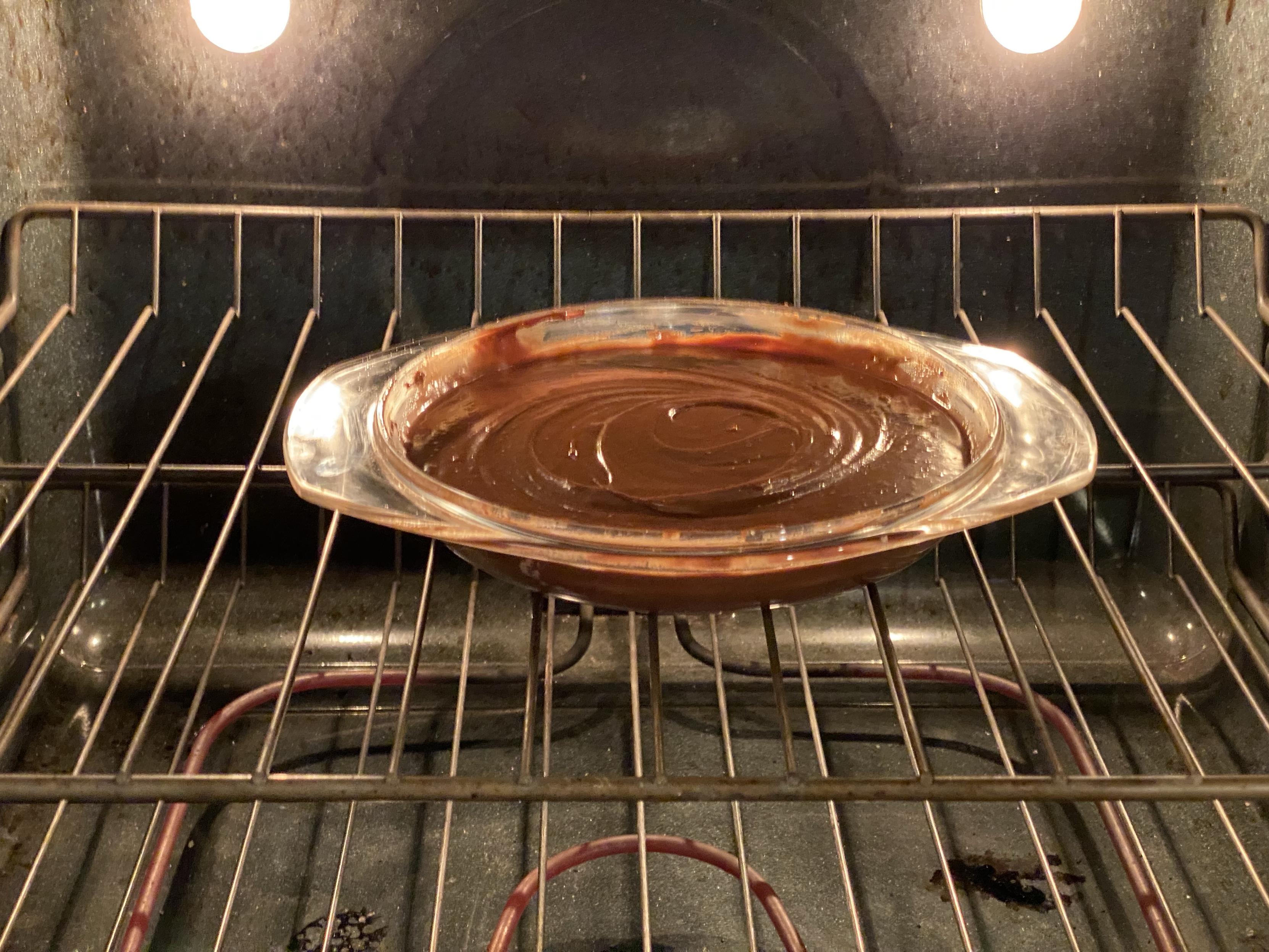 a glass pie plate filled with what looks like choco pudding but is in fact choco kladdkaka dough