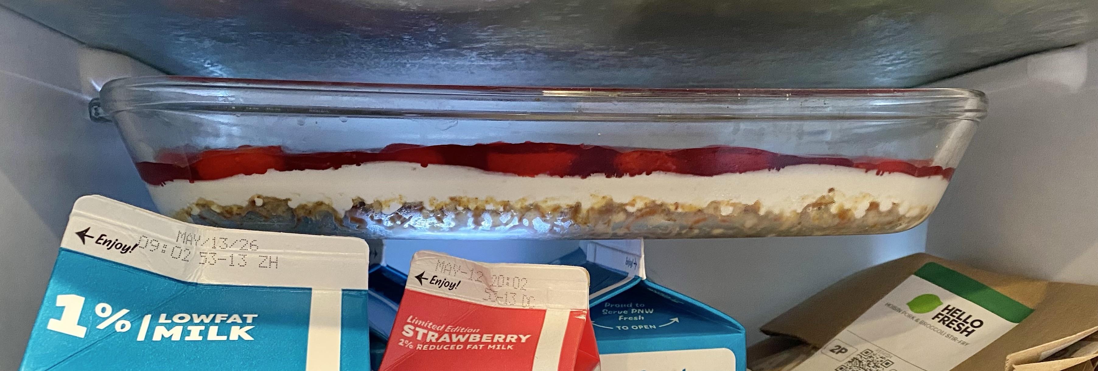 the layered “salad” of strawberries and pretzels and cream in the cold oven (refrigerator) to finish.