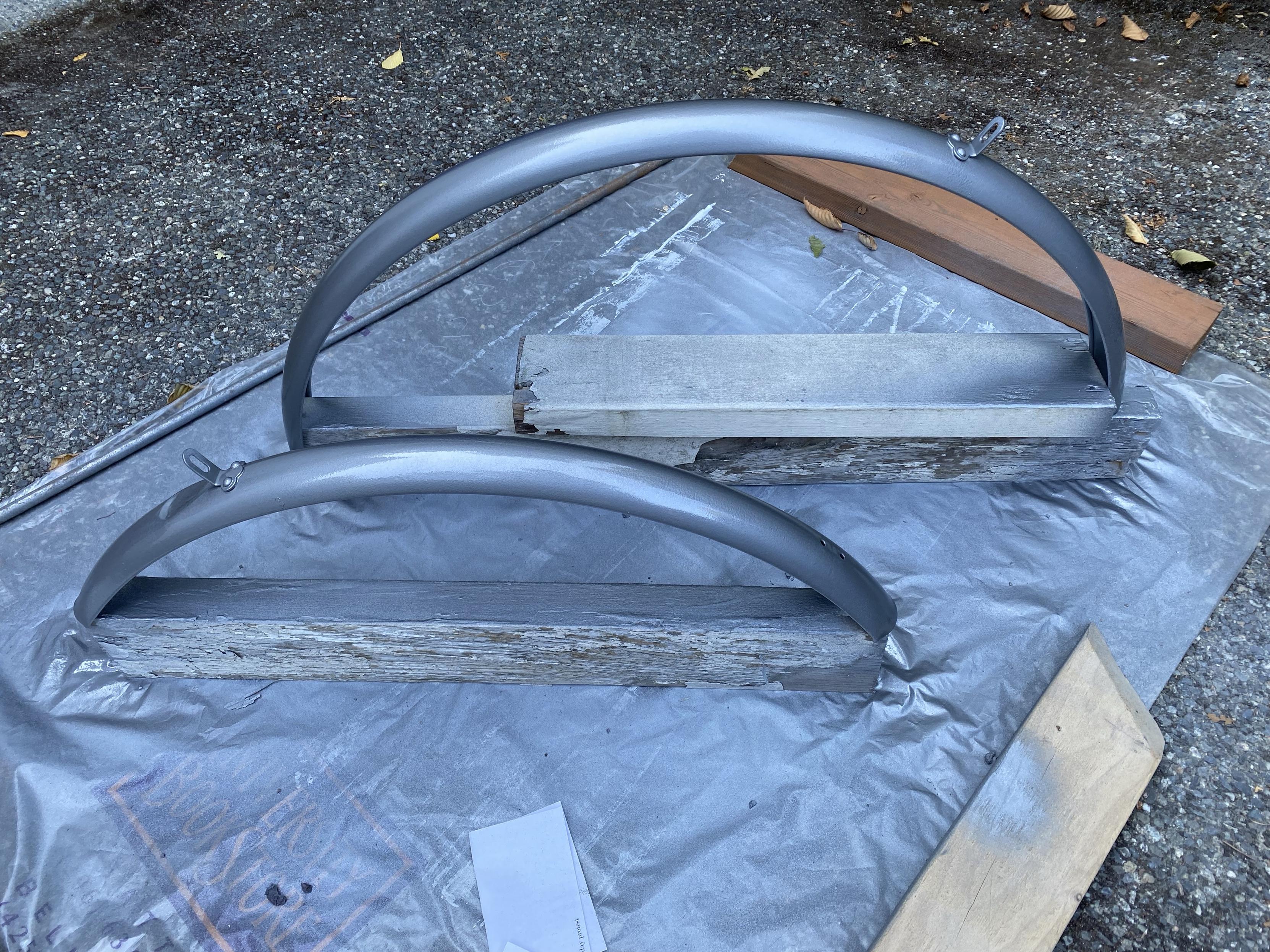a more three-quarters view of the spray painted metal schwinn bike fenders with their latest coat of hammer grey metallic paint