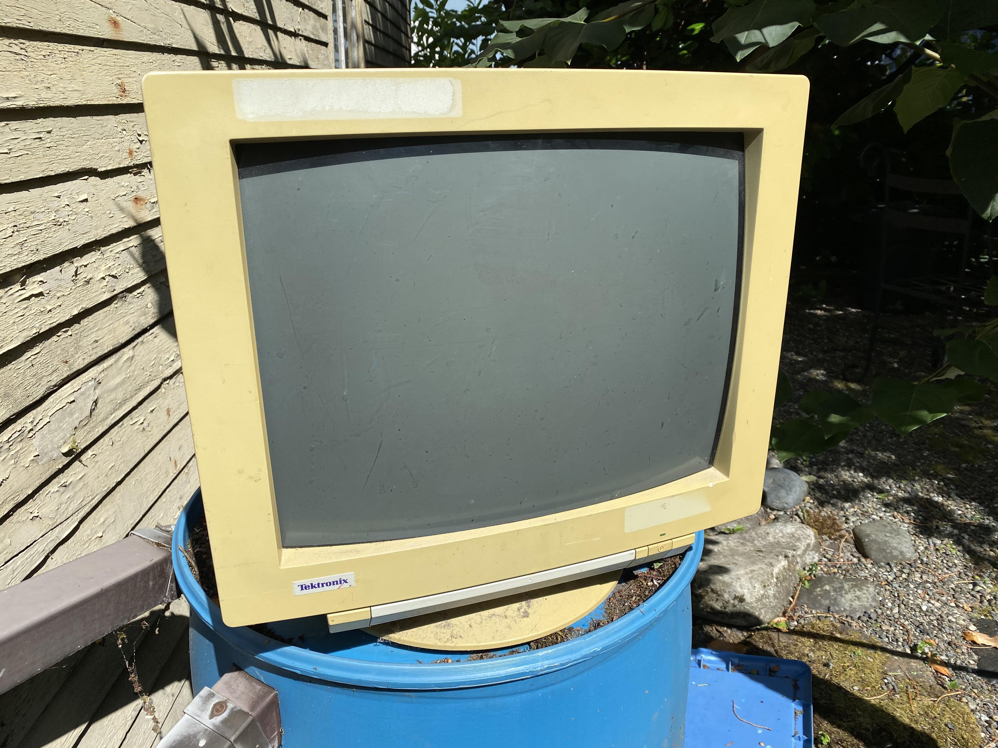 Back of a 1990s Tektronix monitor, very yellowed, with the front control door up/closed, showing that still works.