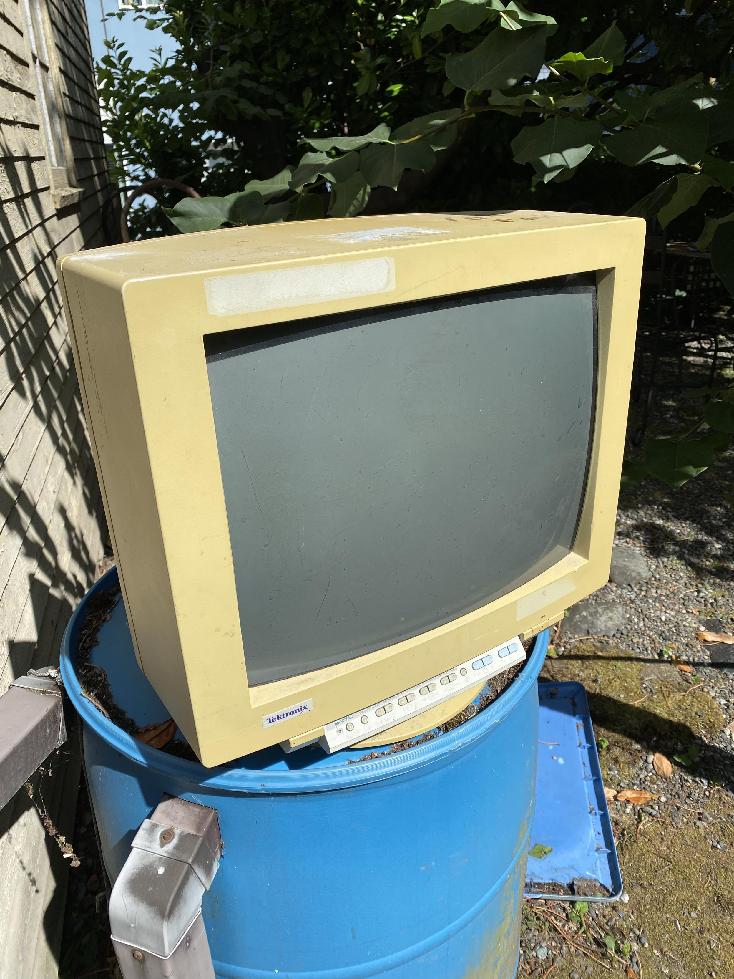 Back of a 1990s Tektronix monitor, very yellowed, showing the front control panel door open, with all the controls inside, not so yellowed at all.
